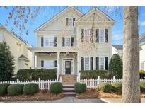 Two story home with a white picket fence and landscaping at 1619 Elegance Dr, Raleigh, NC 27614