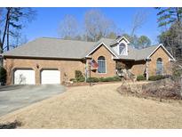 Brick home with two-car garage and landscaped yard at 414 Bakewell Ct, Wake Forest, NC 27587
