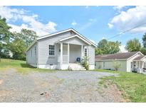 Gray house with front porch and gravel driveway at 425 Potter St, Durham, NC 27701