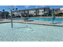 Bright community pool area with lounge chairs, water features, and clear blue water on a sunny day at 5238 Beardall St, Raleigh, NC 27616