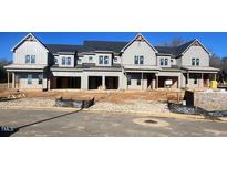 New construction townhome community, featuring three-unit buildings with gray siding and front porches at 1033 Coldspring Circle, Durham, NC 27705