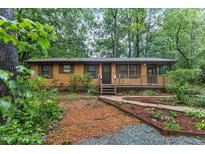 Ranch home with wood siding, deck, and landscaped yard at 114 Cheshire Dr, Hillsborough, NC 27278