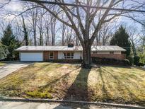 Brick ranch house with attached garage and mature tree at 1205 Glen Eden Dr, Raleigh, NC 27612