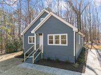 Charming single-story house with gray siding, white trim, inviting front entrance, and well-maintained landscaping at 125 Sue-Kim Dr, Youngsville, NC 27596