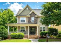 Two-story house with stone accents and a front porch at 13 Fallenwood Ln, Chapel Hill, NC 27516