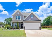 Charming two-story home featuring a spacious two-car garage and beautiful landscaping at 130 Daniel Farm Dr, Benson, NC 27504