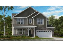 Two-story home with stone accents and a two-car garage at 246 Tidal Pool Way, Cary, NC 27519