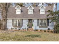 Charming light blue house with gray roof, shutters, and landscaping at 401 Rosehaven Dr, Raleigh, NC 27609
