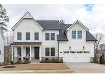 Two-story white house with gray roof, two-car garage, and landscaping at 547 Glenville Lake Dr, Fuquay Varina, NC 27526