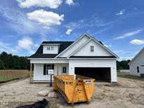 Charming, newly built one-story home featuring white siding, a black roof, and an attached two-car garage at 59 Pretty Run Branch Ln, Wendell, NC 27591