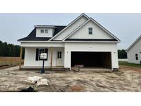 Charming home featuring white siding, a black roof, and an attached two-car garage at 59 Pretty Run Branch Ln, Wendell, NC 27591