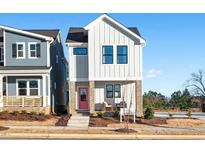 Two-story modern farmhouse with pink door, gray siding, and landscaping at 930 Allen Pk Dr, Raleigh, NC 27604