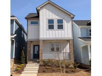 Charming, modern home with white siding, a welcoming entrance, and a well-manicured yard at 930 Allen Pk Dr, Raleigh, NC 27604