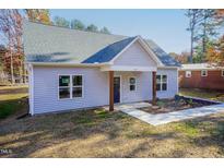 Newly constructed light gray house with a dark blue front door and wood-toned columns at 0 Theresia Ln, Roxboro, NC 27574