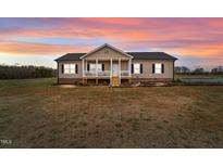 Ranch style home with front porch and landscaped yard at 117 Hinshaw Shop Rd, Liberty, NC 27298