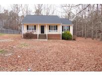 Charming single-story home with a welcoming front porch and well-maintained yard at 119 Lippizanner Pl, Zebulon, NC 27597