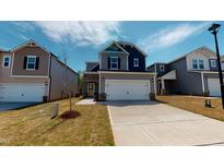 Charming two-story home featuring stone accents, a two-car garage, and a well-manicured front lawn at 120 Anise Tree Way, Clayton, NC 27527
