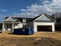 Newly constructed home with attached garage and vinyl siding at 17 Golden View Pl, Zebulon, NC 27597