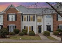 Two-story brick and siding townhouse with a charming front porch at 203 Anniston Ct, Cary, NC 27519