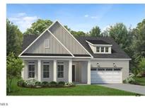 Two-story home with gray siding, white columns, and a two-car garage at 213 Mugby Rd # 171, Raleigh, NC 27610