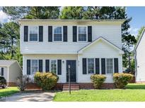 Two-story house with white siding, black shutters, and a well-maintained lawn at 3713 Phillips W Way, Durham, NC 27713