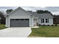 New single-story home with gray siding, a two-car garage, and a well-manicured lawn at 395 Magnolia Run Way, Benson, NC 27504