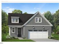 Two-story home with gray siding, a two-car garage, and landscaping at 528 Gainer Dr # 8, Raleigh, NC 27610