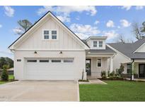 Beautiful craftsman-style home with a light brick facade, two-car garage, and well-manicured lawn at 528 Gainer Dr # 8, Raleigh, NC 27610