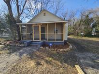 Charming home featuring a screened-in porch and professionally landscaped yard at 611 Rowland St, Henderson, NC 27536