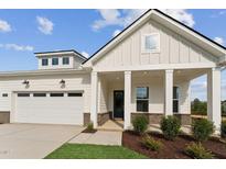 Beautiful home exterior with a well-manicured lawn, covered entrance, and attached garage at 640 Gainer Dr # 21, Raleigh, NC 27610