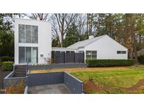 Stunning modern home showcasing a pristine white facade, manicured landscaping, and unique architectural design at 817 Bryan St, Raleigh, NC 27605