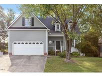 Charming two-story home featuring an attached two-car garage and a welcoming front porch at 1230 Auburn Village Drive Dr, Durham, NC 27713