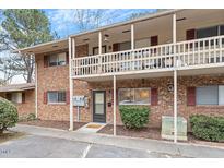 Charming brick townhouse featuring a covered balcony and well-maintained landscaping at 130 S Estes Dr # G3, Chapel Hill, NC 27514