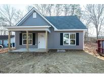 Charming single-story home with gray siding, black shutters, covered porch, and a newly constructed front yard at 2481 Michelle Dr, Burlington, NC 27217