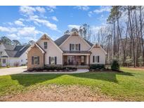 Charming home with a brick and siding exterior, complemented by a beautifully landscaped front yard at 2941 Mt Vernon Church Rd, Raleigh, NC 27613