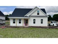 Charming, new construction home with a covered porch and white siding, awaiting its finishing touches at 3963 Baileys Xrds Rd, Benson, NC 27504