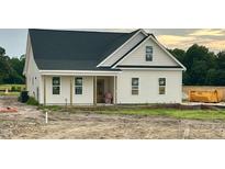 Newly constructed one-story home showcasing a classic exterior design with covered porch and charming curb appeal at 3963 Baileys Xrds Rd, Benson, NC 27504
