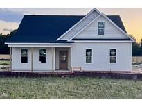 Charming single-story home with a covered porch and black roof ready for new owner at 3963 Baileys Xrds Rd, Benson, NC 27504