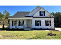 Charming one-story home with white siding, black shutters, covered porch, and well-maintained lawn at 3963 Baileys Xrds Rd, Benson, NC 27504