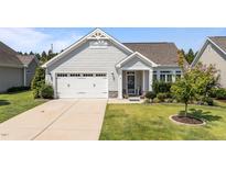 Charming one-story home with a manicured lawn, attached garage, and welcoming front porch at 65 Balsam Ln, Clayton, NC 27527