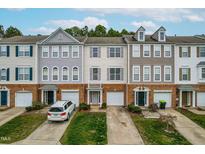 Charming townhomes featuring brick accents, varied siding, and attached garages, creating inviting curb appeal at 707 Sutter Gate Ln, Morrisville, NC 27560