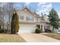 Charming two-story home with a well-manicured front yard and attached two-car garage at 708 Midsummer Ln, Apex, NC 27502