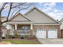 Charming single-story brick home features a cozy front porch and a two-car garage at 812 Canyoncreek Ln, Fuquay Varina, NC 27526