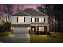 Charming two-story home featuring stone accents, a two-car garage, and a well-maintained lawn at 172 Great Gln, Rocky Mount, NC 27804