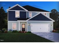 Charming two-story home with blue and gray siding and a two-car garage at 1780 Pie Filling Dr, Haw River, NC 27258
