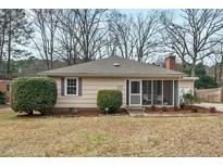 Charming single-story home with neutral siding, manicured landscaping, and a screened-in front porch at 2305 Alabama Ave, Durham, NC 27705