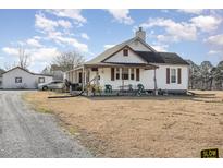 Charming home featuring a covered front porch and spacious front yard at 3158 Us Highway 70 Bus E, Smithfield, NC 27577