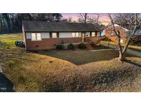 Charming brick home with a cozy front yard and a classic design, perfect for comfortable living at 316 Watson Dr, Burlington, NC 27217