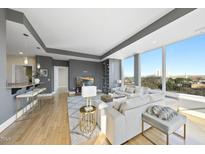 Bright living room featuring hardwood floors, large windows and an open floor plan at 400 W North St # 730, Raleigh, NC 27603