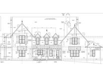 Detailed architectural elevation showcasing the stone veneer, windows, and roofline at 429 Brook Green Ln # 21, Pittsboro, NC 27312